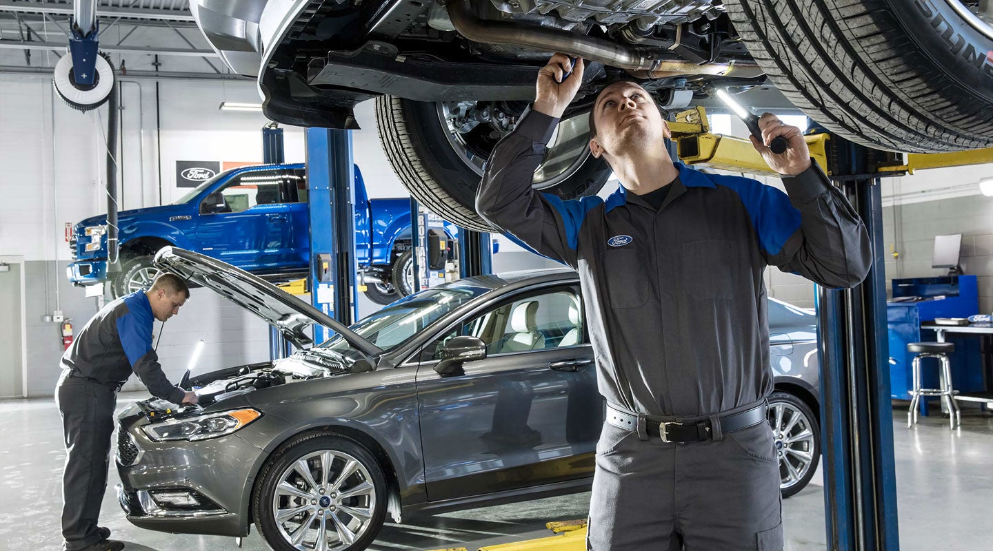service tech working on car Morris Smith Ford of Leavenworth in Leavenworth KS